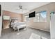 Light-filled main bedroom with a decorative bed, TV, fan and large windows at 15550 W 64Th Pl # D, Arvada, CO 80007