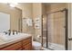 Bathroom features a glass shower, classic fixtures, and ceramic tile at 4545 S Monaco St # 114, Denver, CO 80237