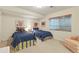 Finished basement bedroom with two twin beds and decor at 4545 S Monaco St # 114, Denver, CO 80237