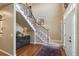 Spacious entryway with hardwood floors, staircase with carpeted steps, and decorative accents at 4545 S Monaco St # 114, Denver, CO 80237