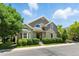 Charming home showcasing lush landscaping, gray siding, gabled roof, and a well-manicured lawn at 4545 S Monaco St # 114, Denver, CO 80237
