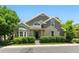 Charming home showcasing lush landscaping, gray siding, gabled roof, and a well-manicured lawn at 4545 S Monaco St # 114, Denver, CO 80237