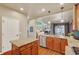 Kitchen with granite countertops, wood cabinets, stainless appliances, and an island at 4545 S Monaco St # 114, Denver, CO 80237