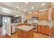Well-lit kitchen with stainless steel appliances, granite countertops, and a spacious island at 4545 S Monaco St # 114, Denver, CO 80237