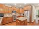 Bright kitchen features wooden cabinets, stainless appliances, and granite counters at 4545 S Monaco St # 114, Denver, CO 80237