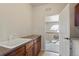 Functional laundry room with sink, cabinets, and an open doorway to another room at 4545 S Monaco St # 114, Denver, CO 80237