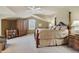 Spacious main bedroom is accented with an ornate bed, vaulted ceilings, and shelving at 4545 S Monaco St # 114, Denver, CO 80237