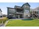Expansive backyard showcasing a multi-story home with a well-maintained lawn and patio at 6955 Sunstrand Ct, Castle Pines, CO 80108