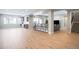 Spacious basement featuring a bar, seating, and stairs, with wood floors and abundant natural light at 6955 Sunstrand Ct, Castle Pines, CO 80108