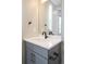 Elegant half bathroom with a modern vanity, light countertops and matte black fixtures at 6955 Sunstrand Ct, Castle Pines, CO 80108