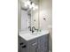 Well-lit bathroom featuring a vanity with sleek fixtures and a modern design at 6955 Sunstrand Ct, Castle Pines, CO 80108