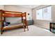 Spacious bedroom with bunk beds, dresser, large window and neutral walls and carpet at 6955 Sunstrand Ct, Castle Pines, CO 80108