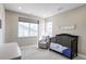 Cozy Bedroom with a comfortable glider, and a decorative sign above a modern crib at 6955 Sunstrand Ct, Castle Pines, CO 80108
