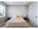 Cozy bedroom featuring a patterned comforter, bedside tables, and abundant natural light at 6955 Sunstrand Ct, Castle Pines, CO 80108