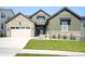 Beautiful exterior home with a stone accents, manicured lawn, and a convenient two-car garage at 6955 Sunstrand Ct, Castle Pines, CO 80108