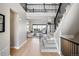 Bright foyer with hardwood floors, staircase, and open view of the living room with comfortable seating at 6955 Sunstrand Ct, Castle Pines, CO 80108