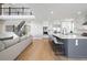 Open-concept design showcasing a bright kitchen with a center island, stainless appliances, and white cabinets at 6955 Sunstrand Ct, Castle Pines, CO 80108