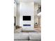 Elegant living room featuring a modern fireplace, flat screen TV, and comfortable sectional sofa at 6955 Sunstrand Ct, Castle Pines, CO 80108