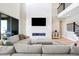 Stylish living room showcasing high ceilings, modern fireplace, large TV, and comfortable sectional sofa at 6955 Sunstrand Ct, Castle Pines, CO 80108