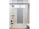 Contemporary shower and tub combination featuring eye catching vertical tile accent and shower curtain at 6955 Sunstrand Ct, Castle Pines, CO 80108