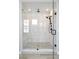 Modern glass enclosed shower stall with bench, tile surround, and black shower fixtures at 6955 Sunstrand Ct, Castle Pines, CO 80108