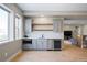 A modern wet bar with stainless steel appliances and sleek cabinetry enhances entertainment options at 6955 Sunstrand Ct, Castle Pines, CO 80108