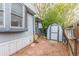A backyard featuring a storage shed, gravel, brick pavers, mature trees and the home's exterior at 8400 Adams Way, Denver, CO 80229