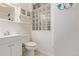A quaint bathroom featuring tile flooring, a glass block window, and white fixtures for a clean, bright space at 8400 Adams Way, Denver, CO 80229