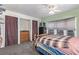 A bedroom with a ceiling fan, carpeted floors, a closet with curtains, and a wooden bed frame at 8400 Adams Way, Denver, CO 80229