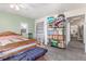 A bedroom with a ceiling fan, carpeted floors, one window, storage shelves and a wooden bed frame at 8400 Adams Way, Denver, CO 80229