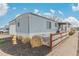 Cozy home with a well-manicured lawn, attached garage, and charming fence creating curb appeal at 8400 Adams Way, Denver, CO 80229