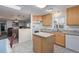 Bright kitchen with an island, ample counter space, and modern appliances at 8400 Adams Way, Denver, CO 80229