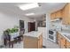 Open kitchen and dining area with a skylight, island, and plenty of storage space at 8400 Adams Way, Denver, CO 80229