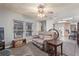 Welcoming living room with large windows, a ceiling fan, and a comfortable sofa at 8400 Adams Way, Denver, CO 80229
