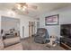 Comfortable living room with a ceiling fan, recliner, cat tree, and a wall-mounted television at 8400 Adams Way, Denver, CO 80229