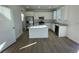 Modern kitchen featuring white cabinets, stainless steel appliances, and an island at 4846 Astor Pl, Brighton, CO 80601