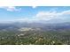 Sweeping mountain view of land with mature trees and rolling hills at 11760 Baca Rd, Conifer, CO 80433