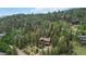 Community aerial showcasing homes nestled among beautiful mature trees at 11760 Baca Rd, Conifer, CO 80433