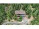 Aerial view of the home featuring a large deck and tree lined property at 11760 Baca Rd, Conifer, CO 80433