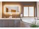 Updated bathroom featuring a double vanity, illuminated mirror, soaking tub and stylish finishes at 11760 Baca Rd, Conifer, CO 80433