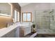 Updated bathroom with double vanity, illuminated mirror, soaking tub and glass shower at 11760 Baca Rd, Conifer, CO 80433