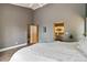 Open bedroom showcases high ceilings, hardwood floors, and an ensuite bathroom at 11760 Baca Rd, Conifer, CO 80433