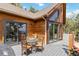 Outdoor deck offers a glass table with chairs, siding doors to indoor, and beautiful mountain views at 11760 Baca Rd, Conifer, CO 80433