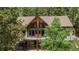 Stunning exterior with floor-to-ceiling windows and a welcoming deck at 11760 Baca Rd, Conifer, CO 80433
