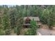 Inviting exterior featuring a charming two-story home nestled amongst lush greenery at 11760 Baca Rd, Conifer, CO 80433