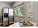 Kitchen with stainless steel refrigerator and a window with a serene view at 11760 Baca Rd, Conifer, CO 80433