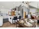 Modern kitchen with an island and seating, open to dining area, and hardwood floors throughout at 11760 Baca Rd, Conifer, CO 80433