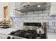 Updated gourmet kitchen with stainless steel appliances, modern backsplash, and granite countertops at 11760 Baca Rd, Conifer, CO 80433