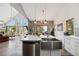 Open kitchen and living area features stainless appliances, large island, fireplace and stunning views at 11760 Baca Rd, Conifer, CO 80433