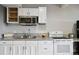Bright kitchen with white cabinets, granite countertops, and stainless steel appliances at 11760 Baca Rd, Conifer, CO 80433